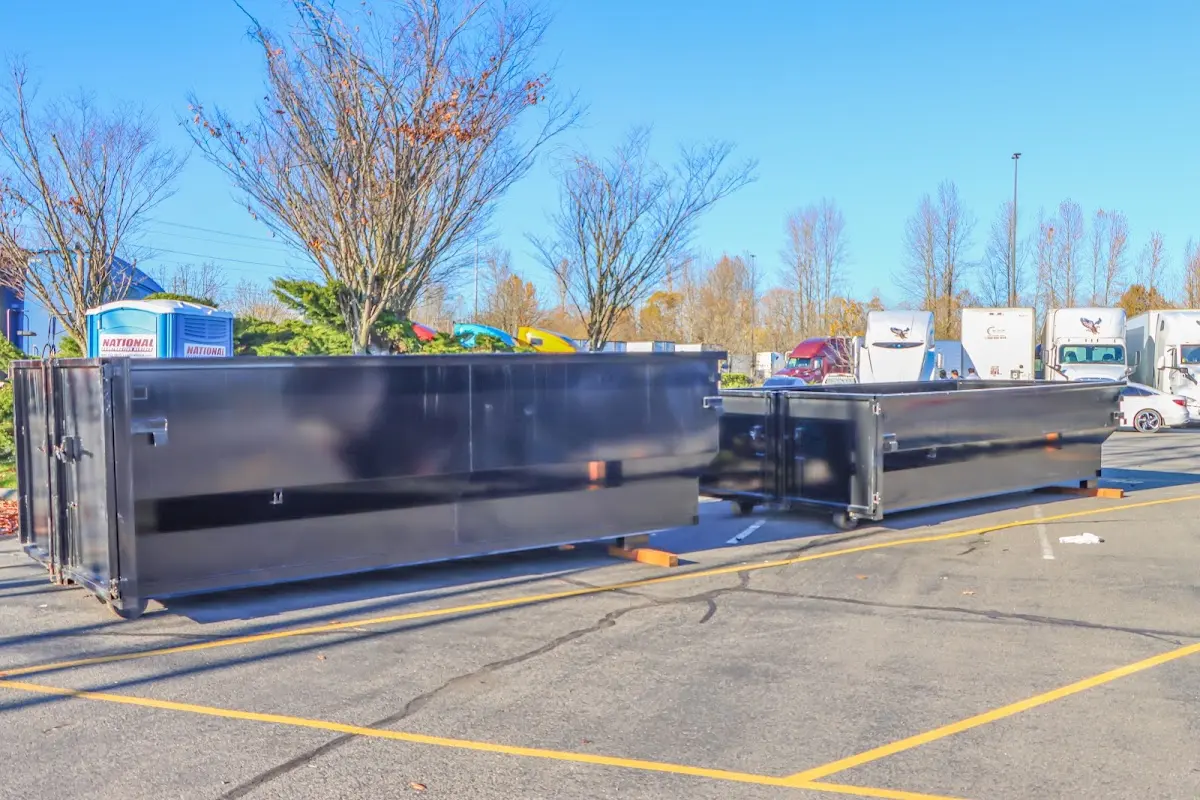 Professional dumpster rental service with roll-off container on residential driveway in Algonquin